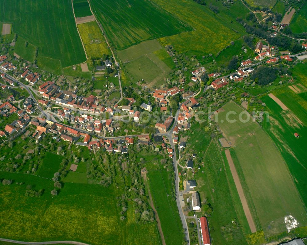 Rüdersdorf from above - Agricultural land and field boundaries surround the settlement area of the village in Ruedersdorf in the state Thuringia, Germany