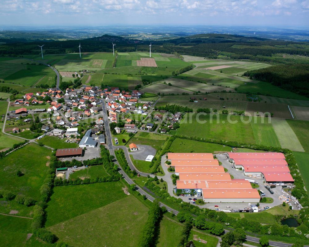 Rebgeshain from the bird's eye view: Agricultural land and field boundaries surround the settlement area of the village in Rebgeshain in the state Hesse, Germany