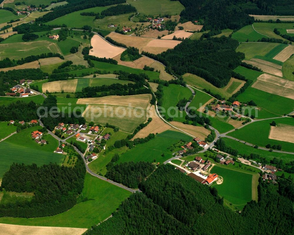 Recksberg from above - Agricultural land and field boundaries surround the settlement area of the village in Recksberg in the state Bavaria, Germany