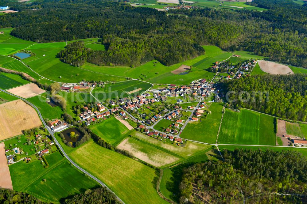 Rehweiler from the bird's eye view: Agricultural land and field boundaries surround the settlement area of the village in Rehweiler in the state Bavaria, Germany