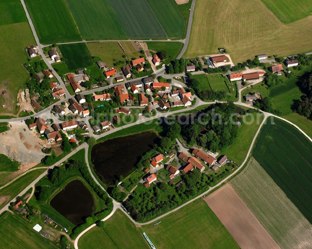 Reichenau from above - Agricultural land and field boundaries surround the settlement area of the village in Reichenau in the state Bavaria, Germany