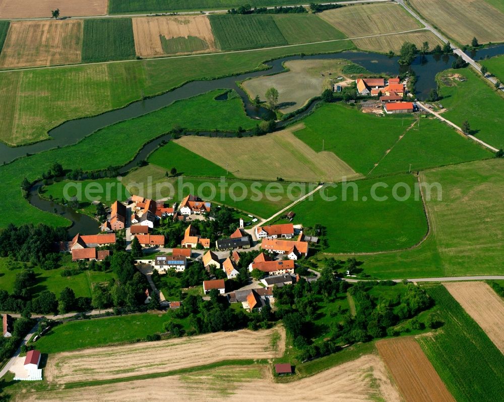 Aerial image Reichenbach - Agricultural land and field boundaries surround the settlement area of the village in Reichenbach in the state Bavaria, Germany