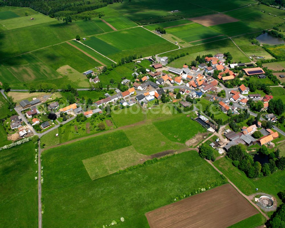 Reichlos from above - Agricultural land and field boundaries surround the settlement area of the village in Reichlos in the state Hesse, Germany