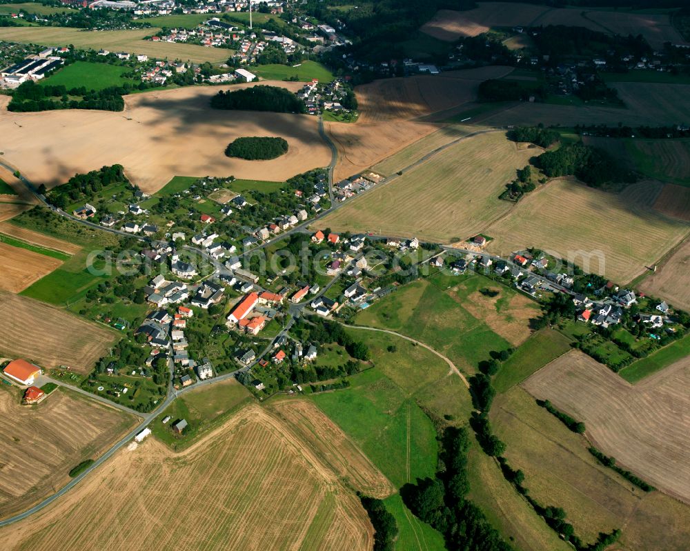 Reinsdorf from above - Agricultural land and field boundaries surround the settlement area of the village in Reinsdorf in the state Thuringia, Germany