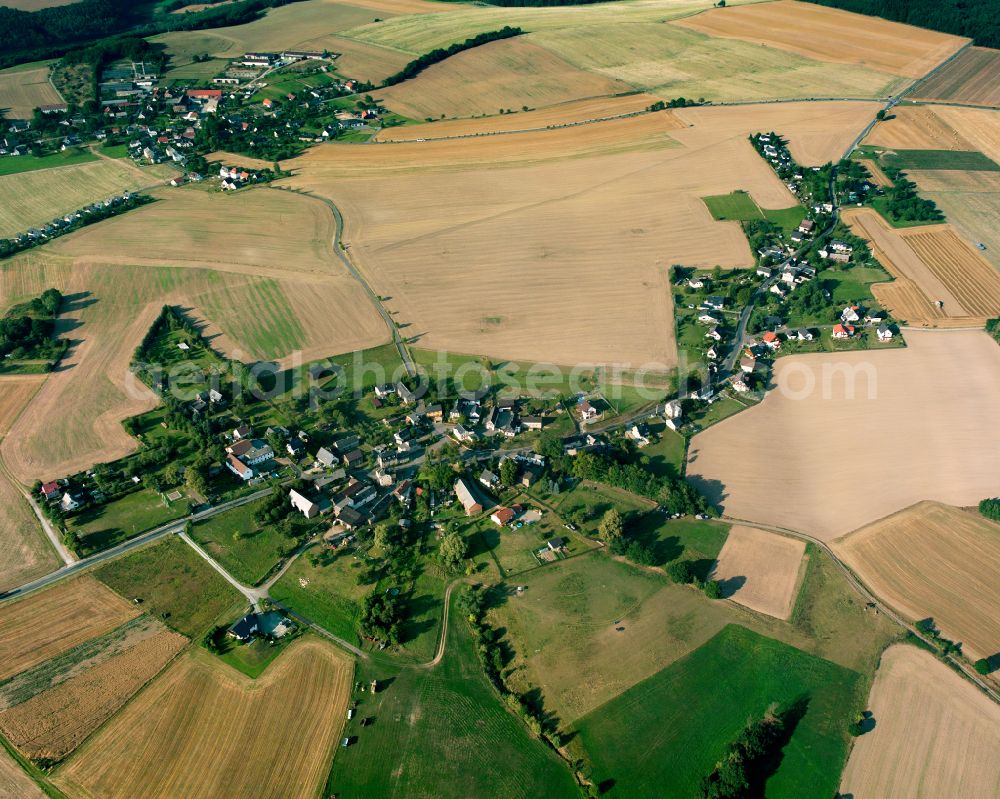 Reinsdorf from above - Agricultural land and field boundaries surround the settlement area of the village in Reinsdorf in the state Thuringia, Germany