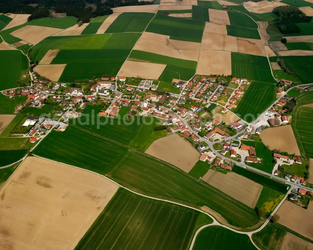 Reißing from above - Agricultural land and field boundaries surround the settlement area of the village in Reißing in the state Bavaria, Germany