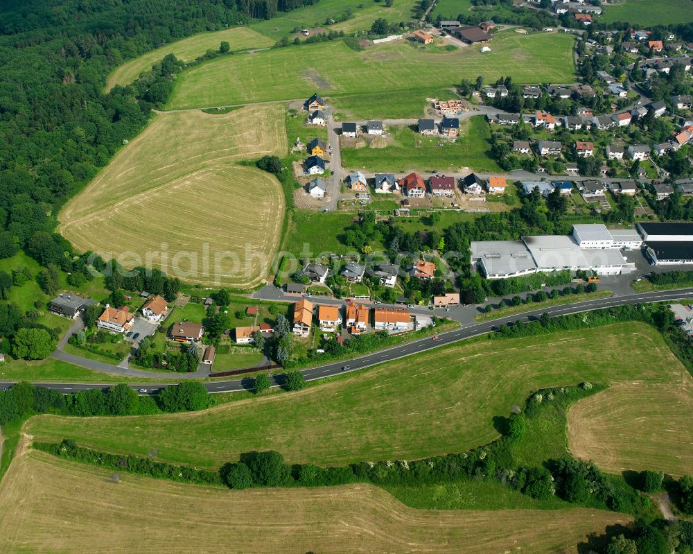 Aerial image Residenz am Stausee - Agricultural land and field boundaries surround the settlement area of the village in Residenz am Stausee in the state Hesse, Germany