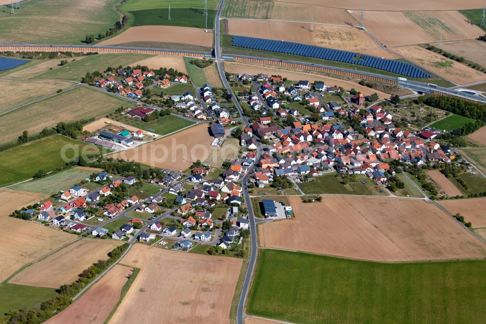 Aerial image Rettersheim - Agricultural land and field boundaries surround the settlement area of the village in Rettersheim in the state Bavaria, Germany