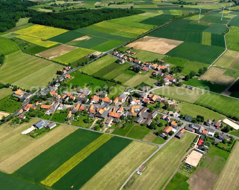 Reuters from above - Agricultural land and field boundaries surround the settlement area of the village in Reuters in the state Hesse, Germany