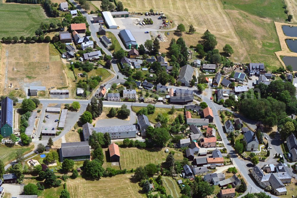 Reuth from above - Agricultural land and field boundaries surround the settlement area of the village in Reuth in the state Saxony, Germany