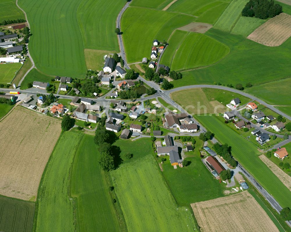 Reuthlas from above - Agricultural land and field boundaries surround the settlement area of the village in Reuthlas in the state Bavaria, Germany