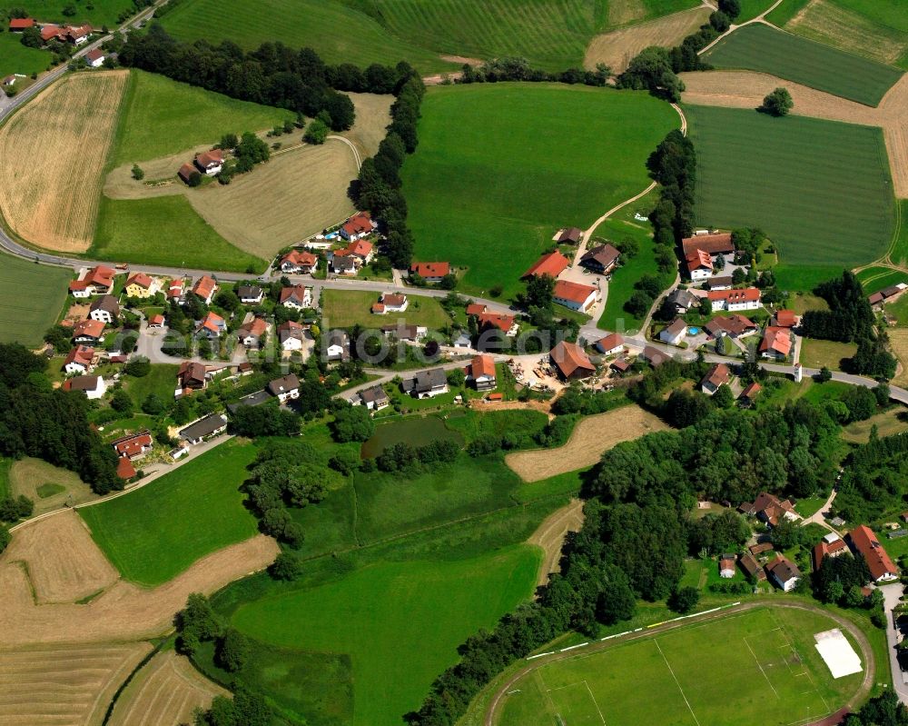 Ried from above - Agricultural land and field boundaries surround the settlement area of the village in Ried in the state Bavaria, Germany