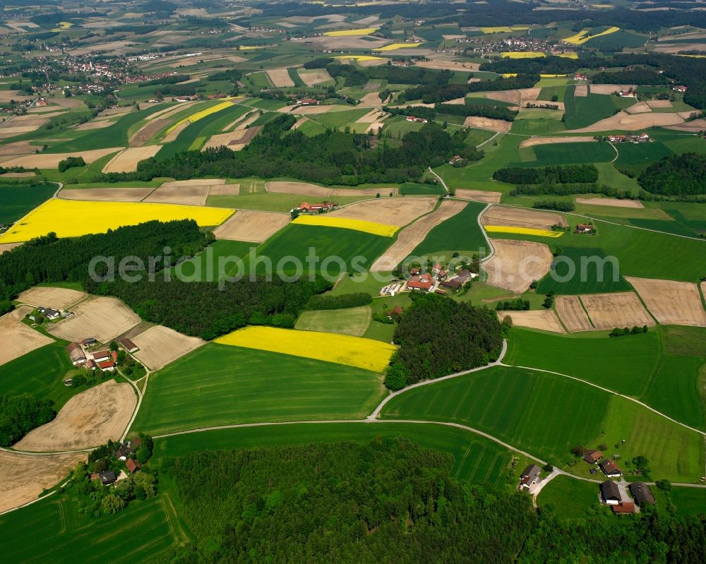 Riegelsberg from the bird's eye view: Agricultural land and field boundaries surround the settlement area of the village in Riegelsberg in the state Bavaria, Germany