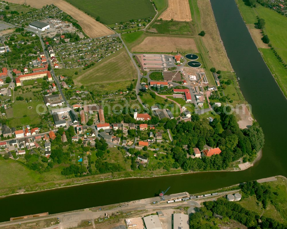 Riesa from above - Agricultural land and field boundaries surround the settlement area of the village in Riesa in the state Saxony, Germany