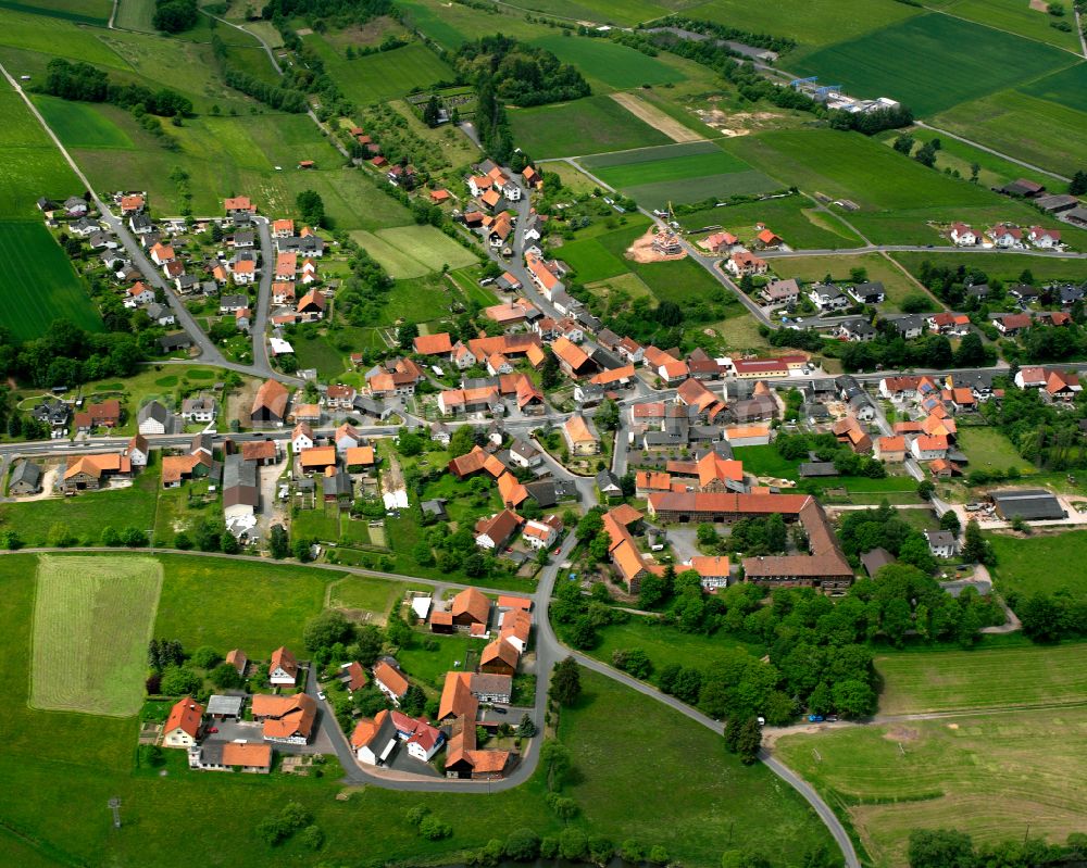 Aerial photograph Rimbach - Agricultural land and field boundaries surround the settlement area of the village in Rimbach in the state Hesse, Germany