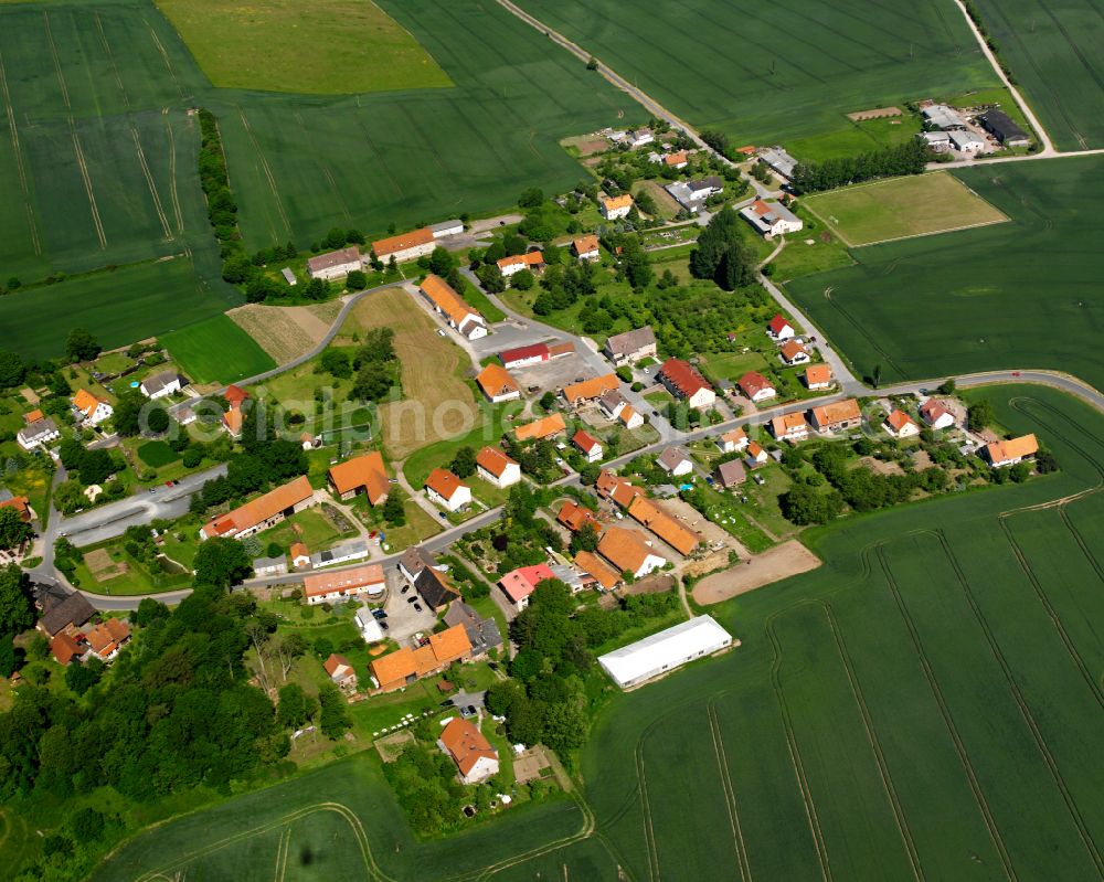 Rimbach from above - Agricultural land and field boundaries surround the settlement area of the village in Rimbach in the state Thuringia, Germany