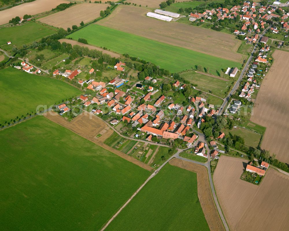 Rimbeck from above - Agricultural land and field boundaries surround the settlement area of the village in Rimbeck in the state Saxony-Anhalt, Germany