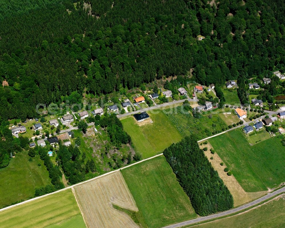 Rinzenberg from above - Agricultural land and field boundaries surround the settlement area of the village in Rinzenberg in the state Rhineland-Palatinate, Germany