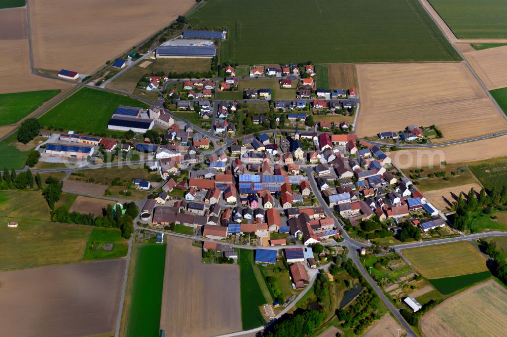 Rittershausen from the bird's eye view: Agricultural land and field boundaries surround the settlement area of the village in Rittershausen in the state Bavaria, Germany