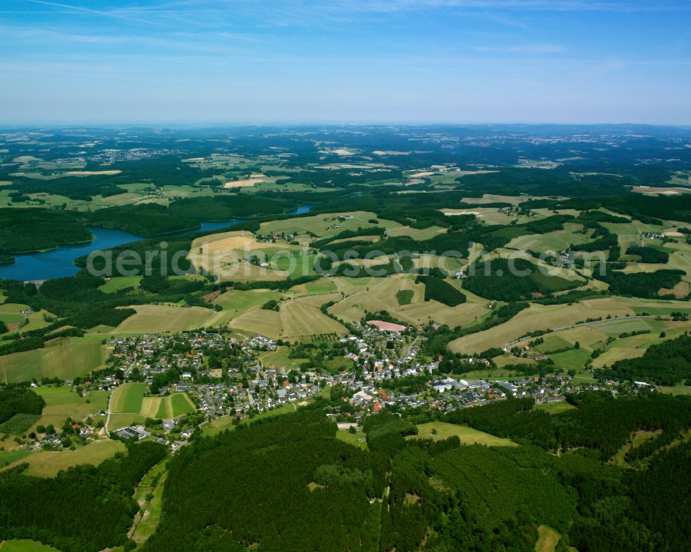 Rönsahl from above - Agricultural land and field boundaries surround the settlement area of the village in Rönsahl in the state North Rhine-Westphalia, Germany