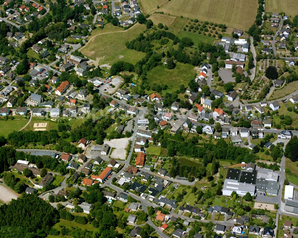 Rönsahl from above - Agricultural land and field boundaries surround the settlement area of the village in Rönsahl in the state North Rhine-Westphalia, Germany