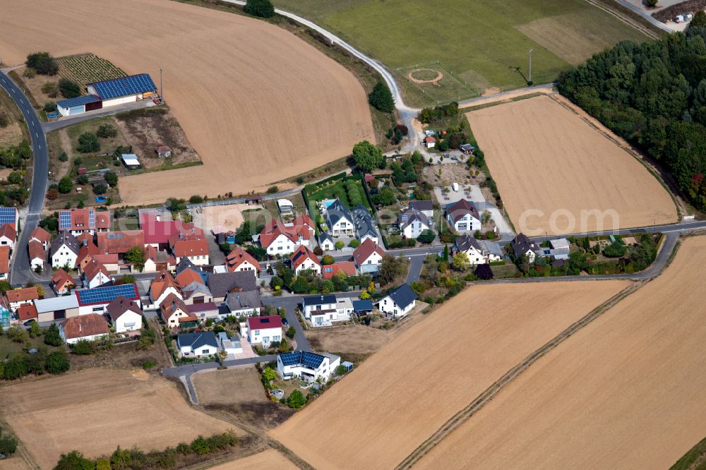 Rohrbach from above - Agricultural land and field boundaries surround the settlement area of the village in Rohrbach in the state Bavaria, Germany