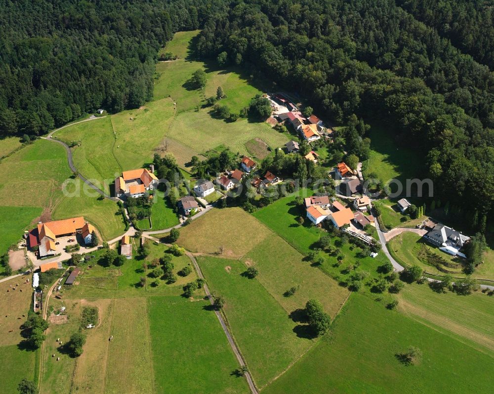 Rohrbach from the bird's eye view: Agricultural land and field boundaries surround the settlement area of the village in Rohrbach in the state Hesse, Germany