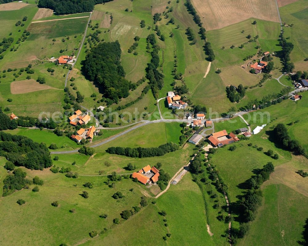 Aerial photograph Rohrbach - Agricultural land and field boundaries surround the settlement area of the village in Rohrbach in the state Hesse, Germany