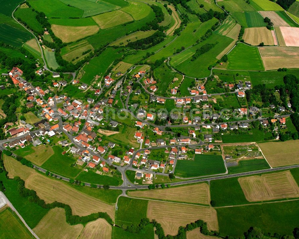 Aerial photograph Rohrbach - Agricultural land and field boundaries surround the settlement area of the village in Rohrbach in the state Hesse, Germany