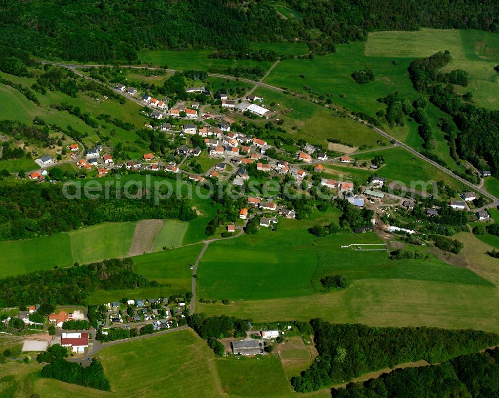 Rohrbach from the bird's eye view: Agricultural land and field boundaries surround the settlement area of the village in Rohrbach in the state Rhineland-Palatinate, Germany