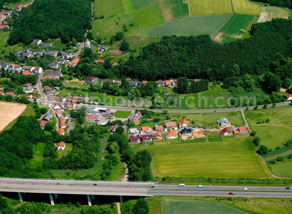 Rohrbach from above - Agricultural land and field boundaries surround the settlement area of the village in Rohrbach in the state Rhineland-Palatinate, Germany