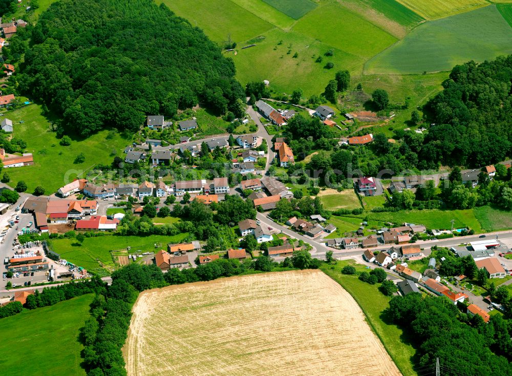 Rohrbach from the bird's eye view: Agricultural land and field boundaries surround the settlement area of the village in Rohrbach in the state Rhineland-Palatinate, Germany