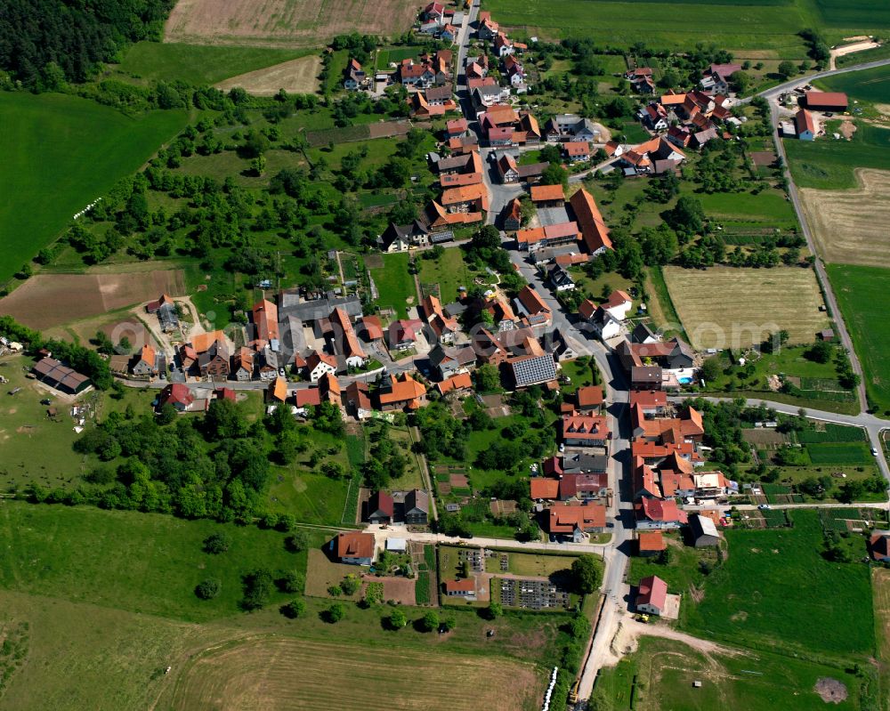 Rohrberg from above - Agricultural land and field boundaries surround the settlement area of the village in Rohrberg in the state Thuringia, Germany