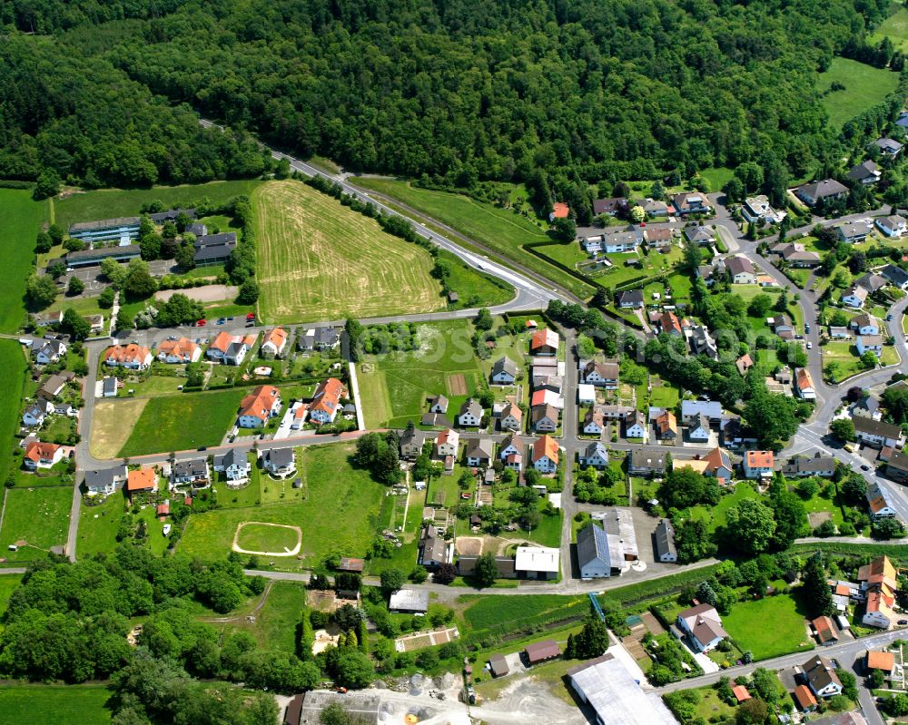 Aerial image Romrod - Agricultural land and field boundaries surround the settlement area of the village in Romrod in the state Hesse, Germany