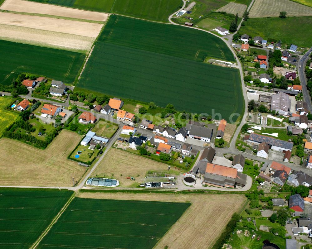 Aerial photograph Romrod - Agricultural land and field boundaries surround the settlement area of the village in Romrod in the state Hesse, Germany