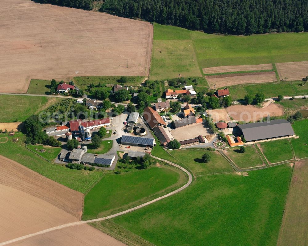 Roßbach from the bird's eye view: Agricultural land and field boundaries surround the settlement area of the village in Roßbach in the state Hesse, Germany