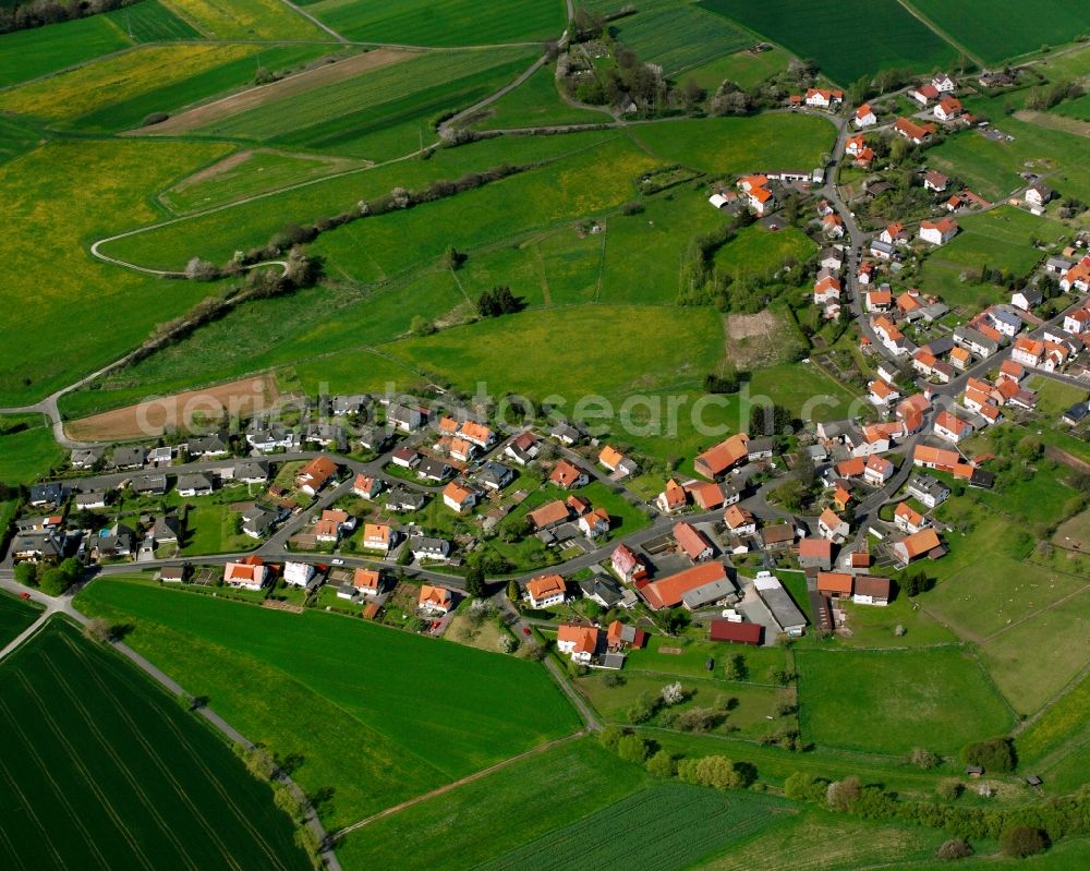 Rotensee from above - Agricultural land and field boundaries surround the settlement area of the village in Rotensee in the state Hesse, Germany