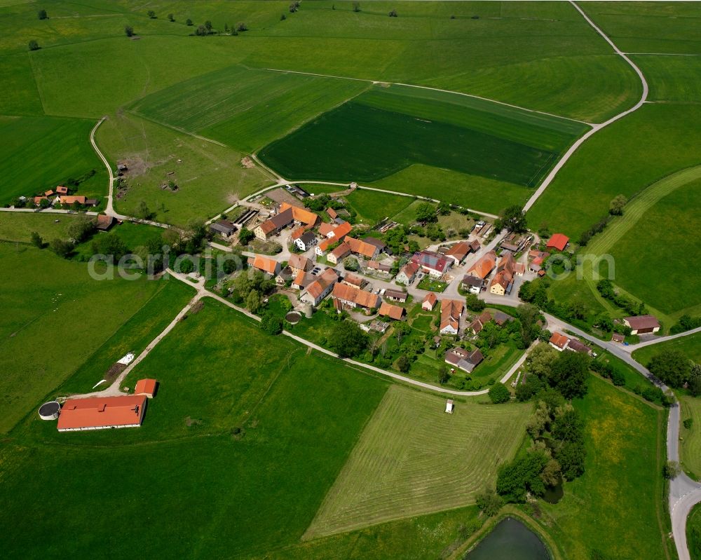 Röttenbach from above - Agricultural land and field boundaries surround the settlement area of the village in Röttenbach in the state Bavaria, Germany