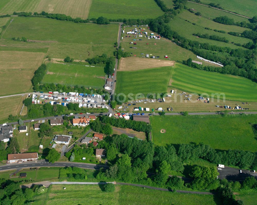 Aerial photograph Rudingshain - Agricultural land and field boundaries surround the settlement area of the village in Rudingshain in the state Hesse, Germany