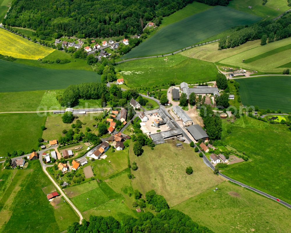 Aerial image Rudlos - Agricultural land and field boundaries surround the settlement area of the village in Rudlos in the state Hesse, Germany