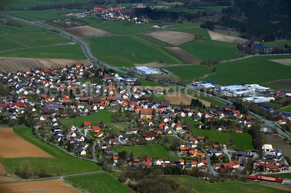 Aerial image Rugendorf - Agricultural land and field boundaries surround the settlement area of the village in Rugendorf in the state Bavaria, Germany