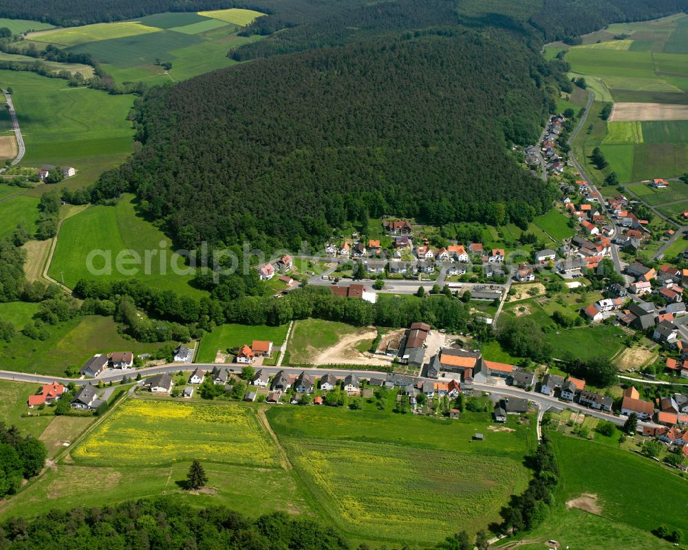 Aerial image Ruhlkirchen - Agricultural land and field boundaries surround the settlement area of the village in Ruhlkirchen in the state Hesse, Germany