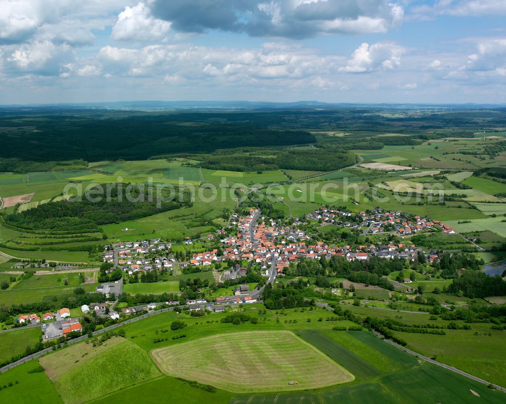 Ruppertenrod from above - Agricultural land and field boundaries surround the settlement area of the village in Ruppertenrod in the state Hesse, Germany