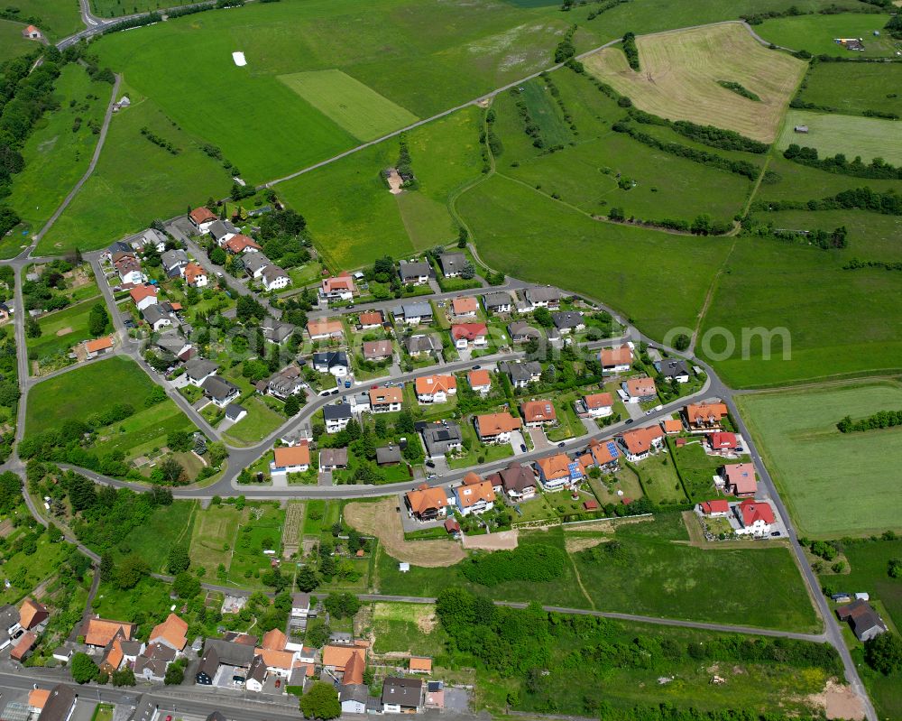 Ruppertenrod from above - Agricultural land and field boundaries surround the settlement area of the village in Ruppertenrod in the state Hesse, Germany