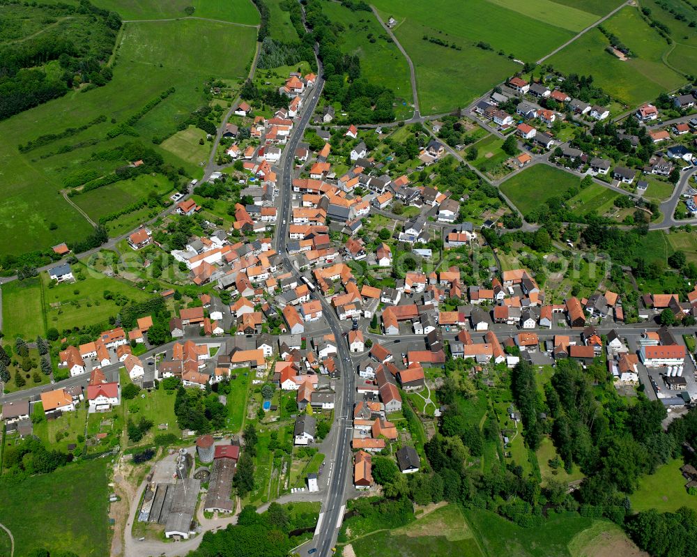 Ruppertenrod from the bird's eye view: Agricultural land and field boundaries surround the settlement area of the village in Ruppertenrod in the state Hesse, Germany