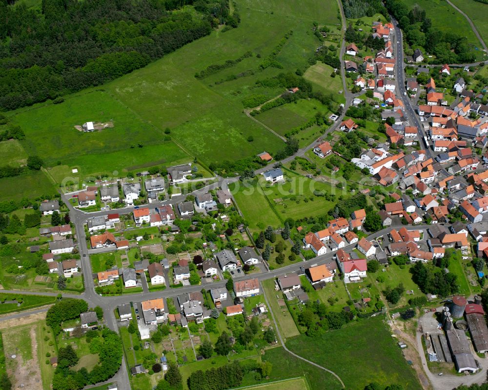 Aerial image Ruppertenrod - Agricultural land and field boundaries surround the settlement area of the village in Ruppertenrod in the state Hesse, Germany