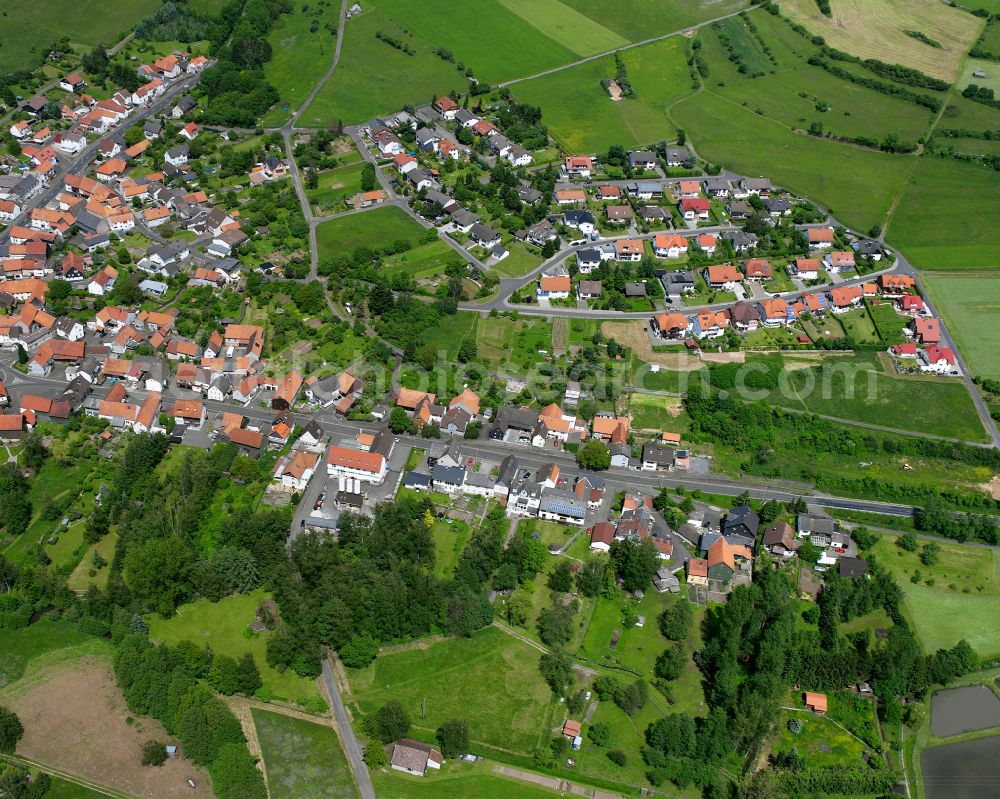 Aerial photograph Ruppertenrod - Agricultural land and field boundaries surround the settlement area of the village in Ruppertenrod in the state Hesse, Germany