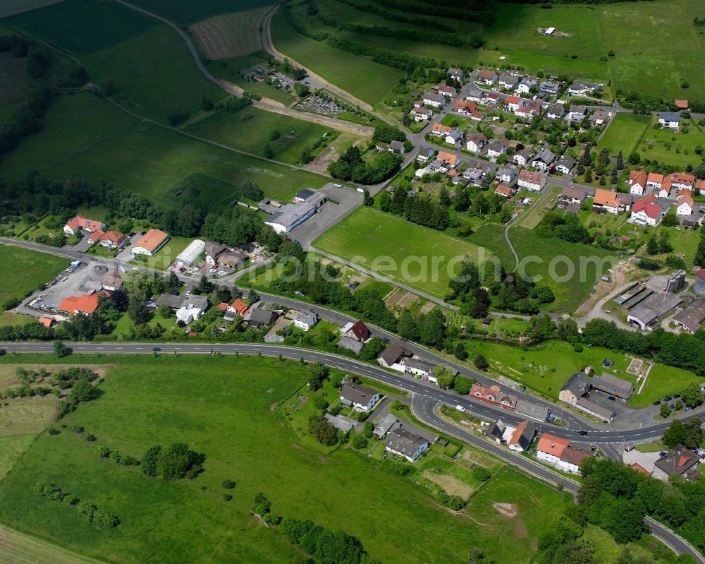 Ruppertenrod from above - Agricultural land and field boundaries surround the settlement area of the village in Ruppertenrod in the state Hesse, Germany