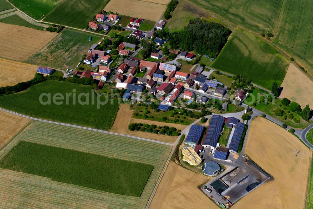 Rupprechtshausen from the bird's eye view: Agricultural land and field boundaries surround the settlement area of the village in Rupprechtshausen in the state Bavaria, Germany