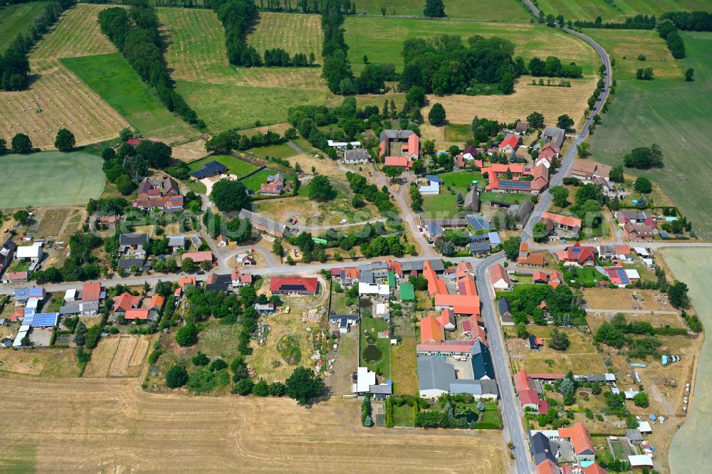 Sachau from above - Agricultural land and field boundaries surround the settlement area of the village in Sachau in the state Saxony-Anhalt, Germany